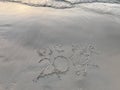 `bye bye 2017` written words on sunset beach